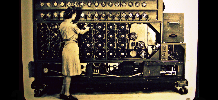 US Navy Cryptanalytic Bombe Woman in 1940s garb standing in front of a huge machine with lots of rotors